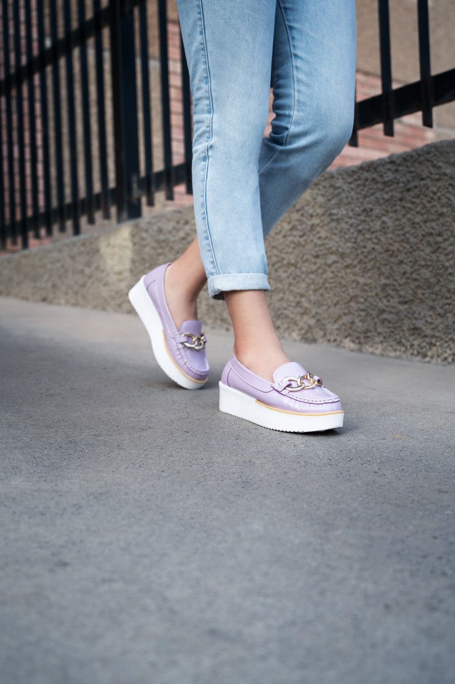Person walking on a sidewalk in comfortable loafers